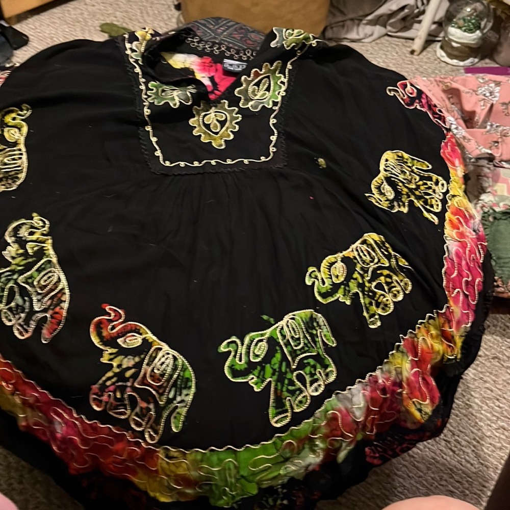 A black top with elephants, and then embroidery around the elephant and neckline